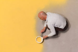 Wolfgang Laib. Installing <i>Pollen from Hazelnut</i> in the Marron Atrium at The Museum of Modern Art, 2013. Photograph by Jason Mandella. Wolfgang Laib. Installing Pollen from Hazelnut in the Marron Atrium at The Museum of Modern Art, 2013. Photograph by Jason Mandella.